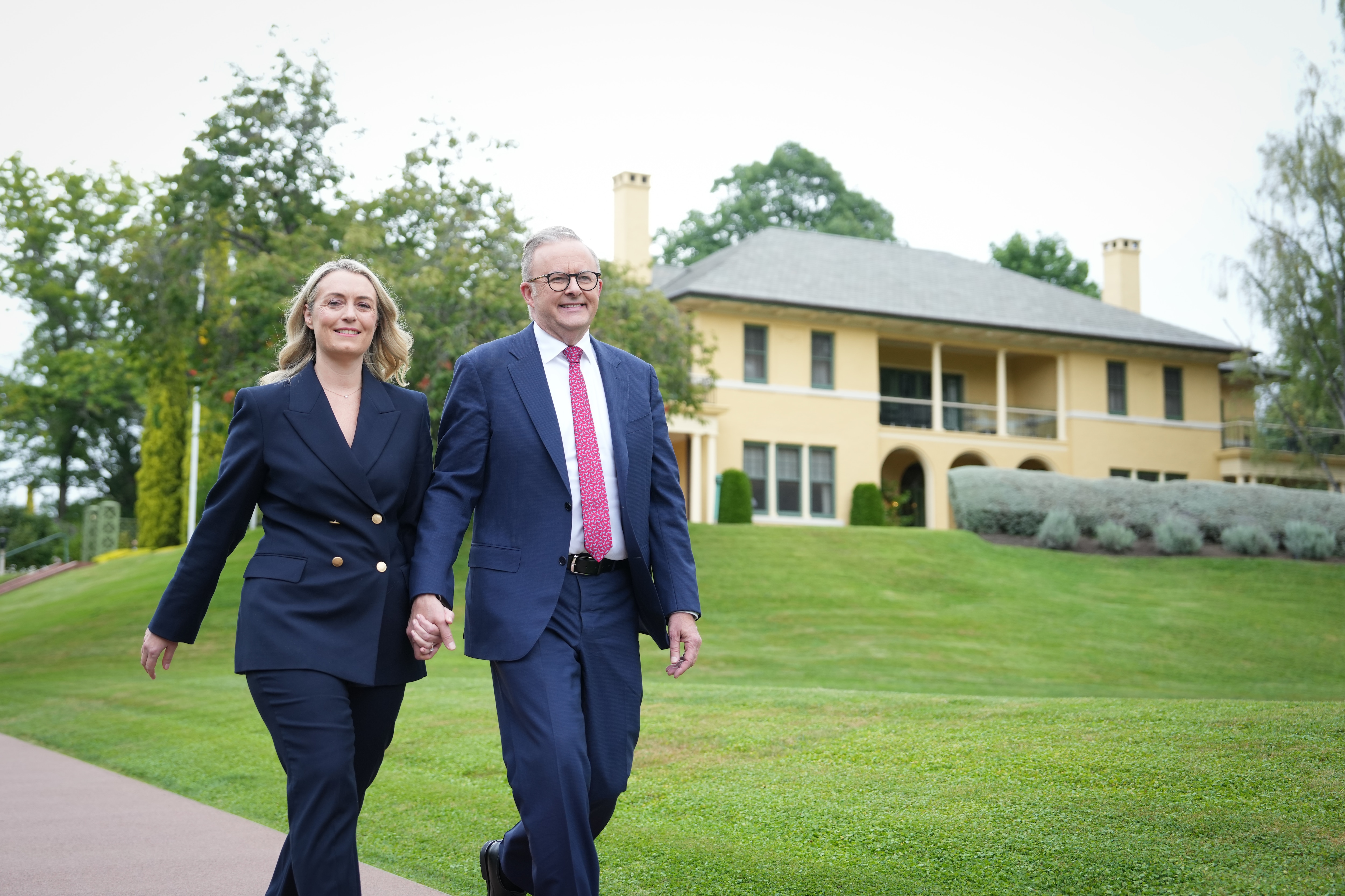 Albanese and his new fiancee Jodie Hayden walk hand in hand outside the Lodge. 