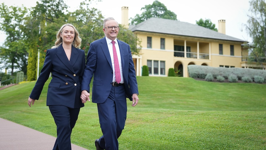 Albanese and his new fiancee Jodie Hayden walk hand in hand outside the Lodge. 