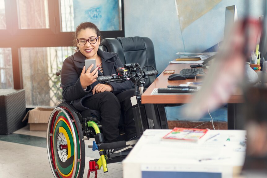 Woman in a wheelchair with brightly coloured wheels