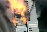 An aerial photo of orange flames in an industrial setting.