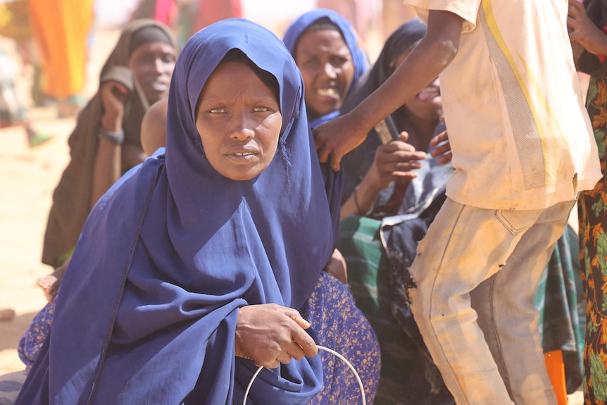 A woman looks at the camera.