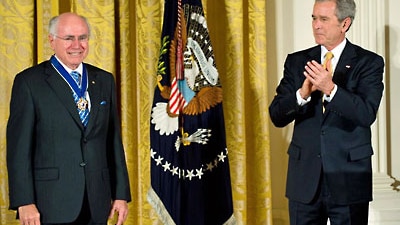 George W Bush applauds former prime minister John Howard (AFP: Saul Loeb)