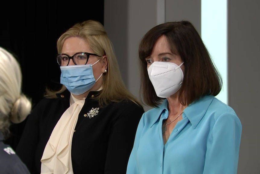 Two women wearing face masks