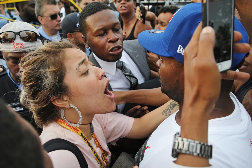 woman tries to come down man in large crowd