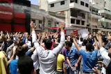 Protests continue: A fire truck sprays water at anti-regime protesters in Syria