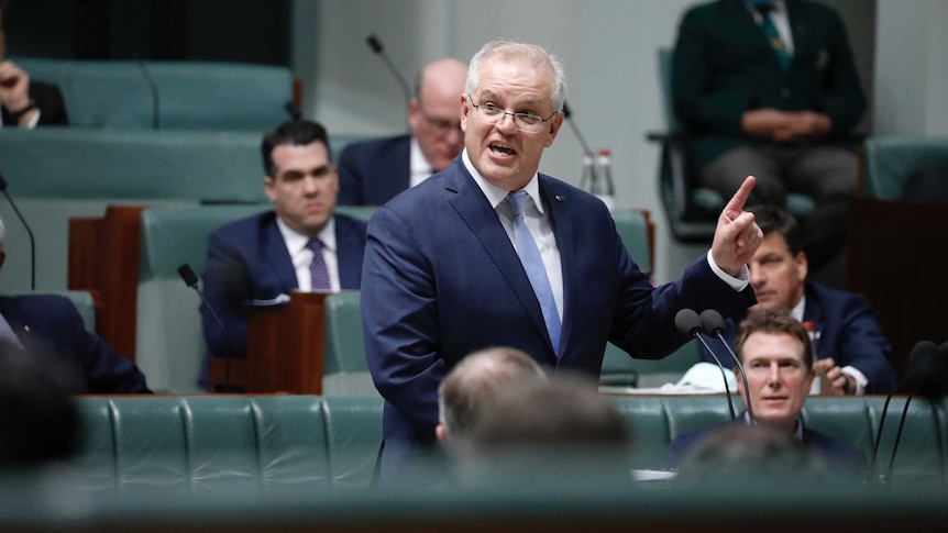 A lower floor angle, Morrison on his feet, left index finger pointing in the air.