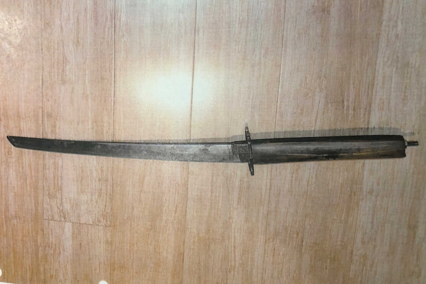 A short sword with a brown handle.