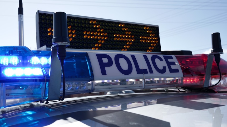 Police lights and a sign sitting on top of a police car