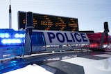 Police lights and a sign sitting on top of a police car