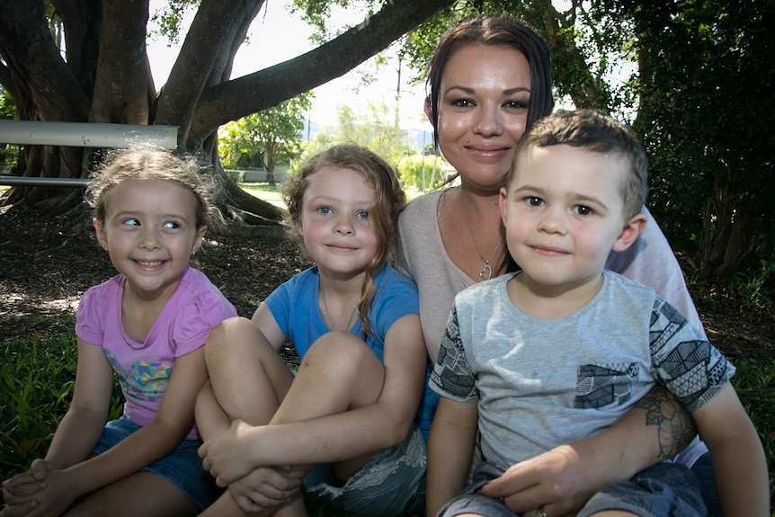 Photo of 27 year old mum Janelle with her three small children outside