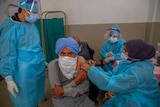 a man receives a vaccine for COVID-19 at a primary health center in Srinagar, Indian controlled Kashmir.