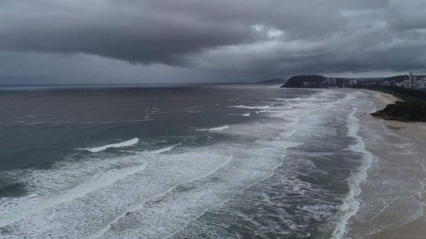 A storm hanging low over a beach.