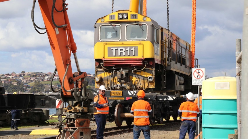 The TasRail locomotive is lifted after derailing incident, Devonport