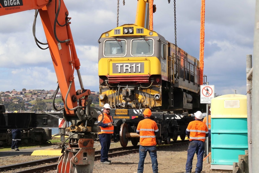 The TasRail locomotive is lifted after derailing incident, Devonport