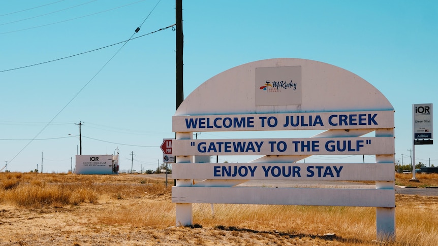 A white welcome sign into the rural town of Julia Creek