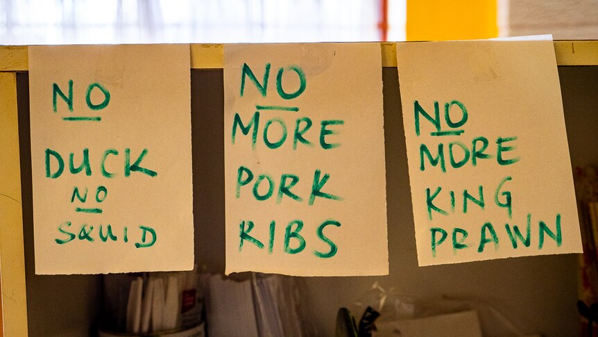 Pieces of paper with written notes displaying shortage of ingredients for Chinese meals.