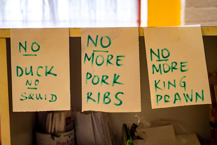 Pieces of paper with written notes displaying shortage of ingredients for Chinese meals.