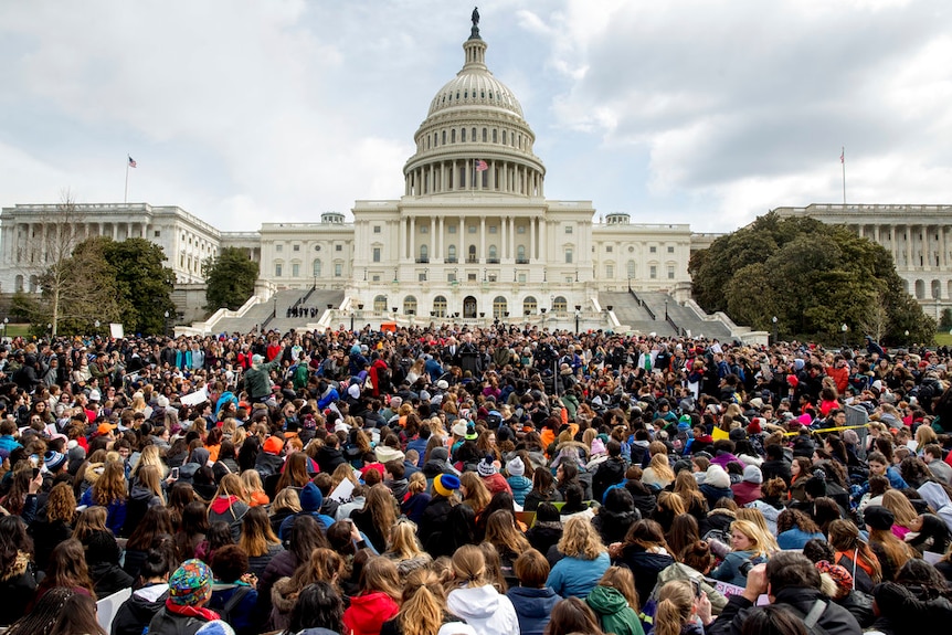 Thousands of students sit outside the US capitol in DC