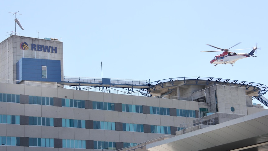 Helicopter lands on helipad on top of the RBWH.