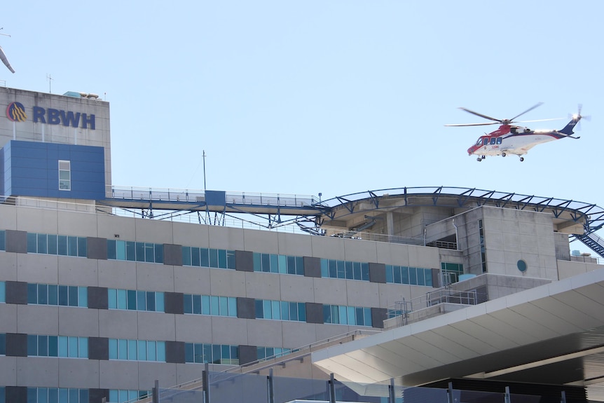 Helicopter lands on helipad on top of the RBWH.