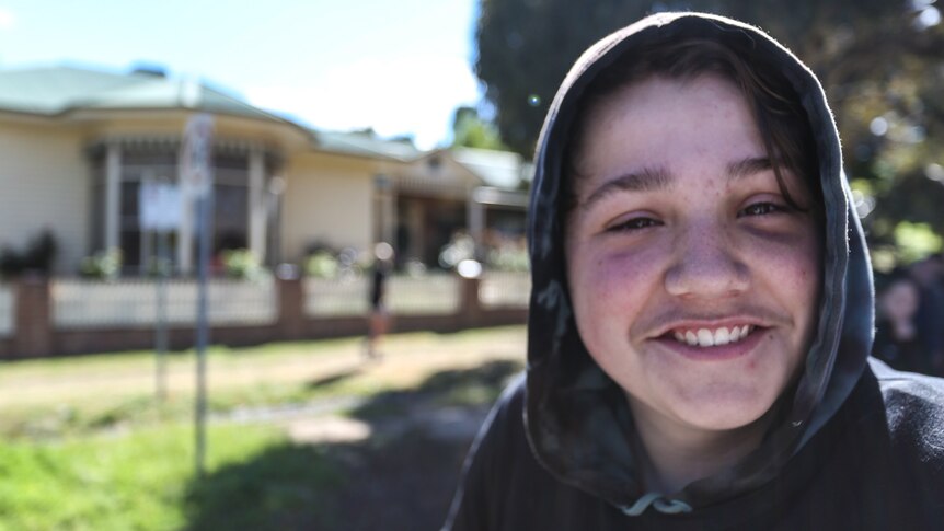 A close up of 14-year-old, Chase smiling.