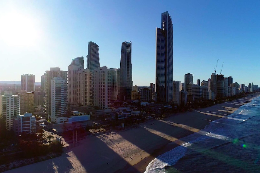 Tall buildings next to beach.