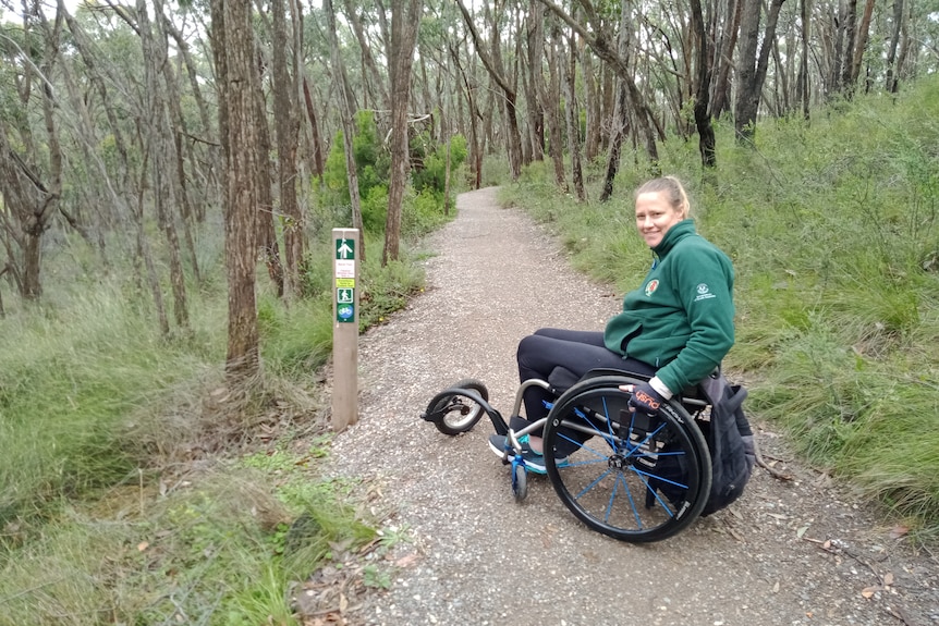 Yvette Eglinton riding along a walking trail in a wheelchair. 