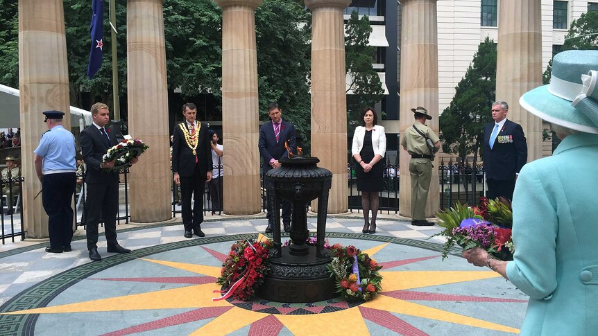 Dignitaries lay wreaths at a Remembrance Day service at ANZAC Square in Brisbane.
