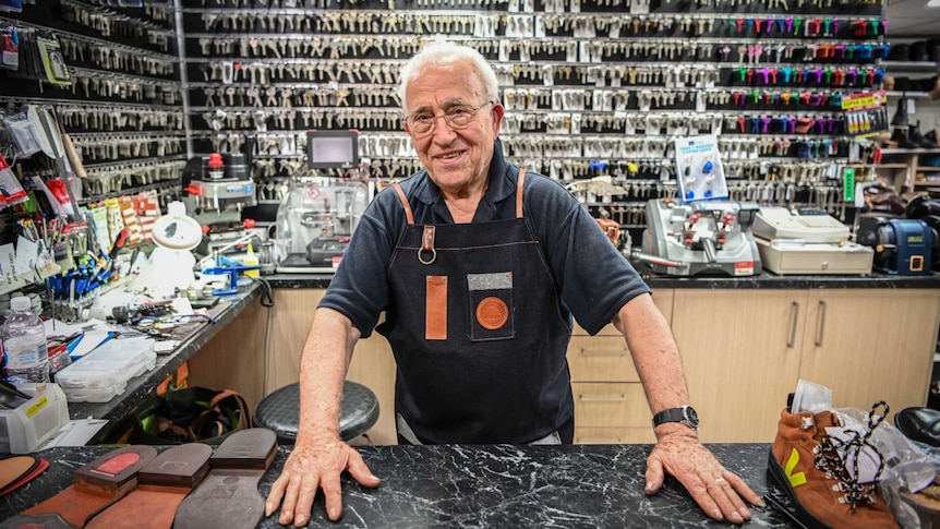 An old man in a key-cutting shop