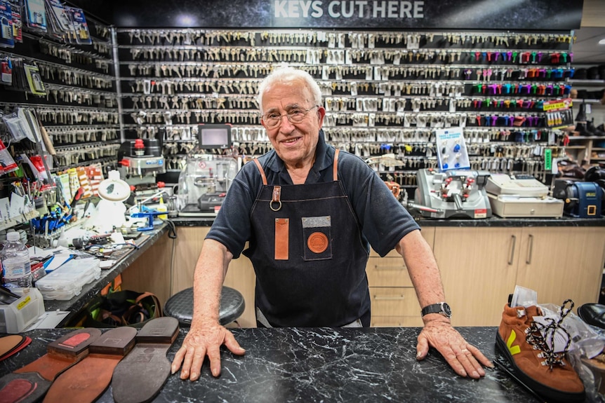 An old man in a key-cutting shop