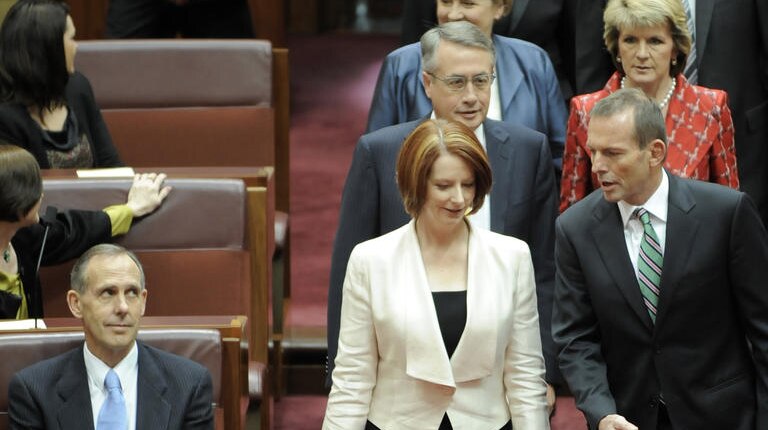 Prime Minister Julia Gillard and Opposition Leader Tony Abbott enter the Senate at the opening of the 43rd Parliament (AAP)