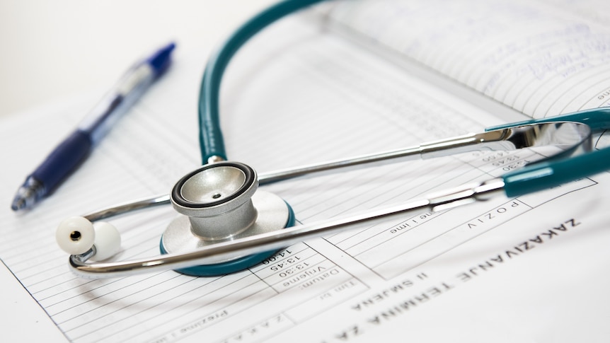 Close-up photo of a silver and white stethoscope.