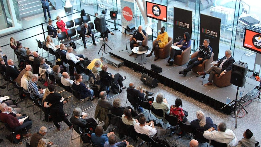 An audience gathers on seats in the ABC Melbourne foyer as a panel discusses the issue of youth crime.