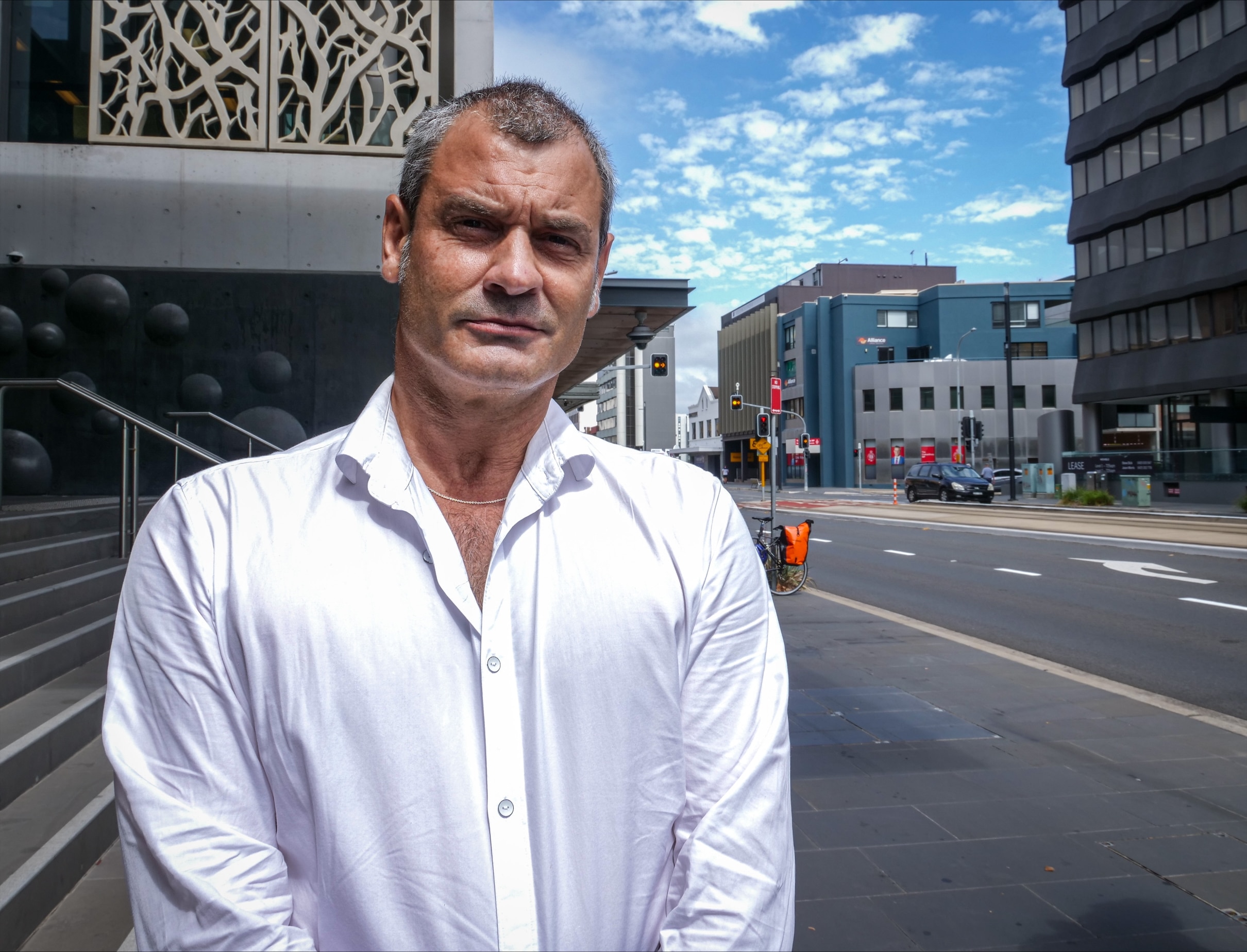 A man standing outside of court.
