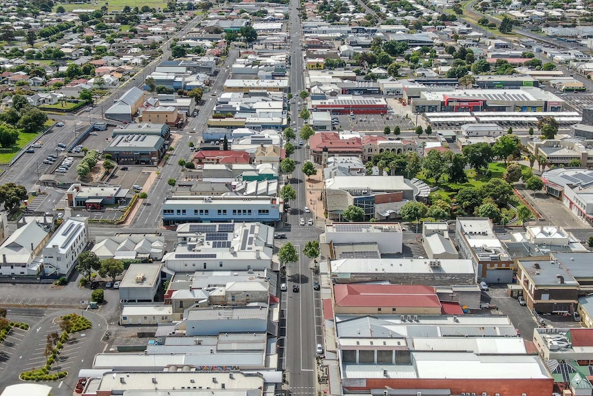 An aerial phpto of a medium-sized town with few cars on the roads.