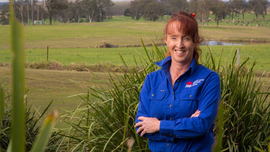 Kyra O'Brien stands in a paddock.