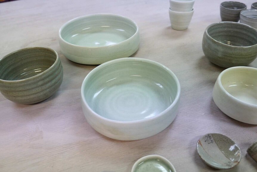 different shaped bowls in different shades of green