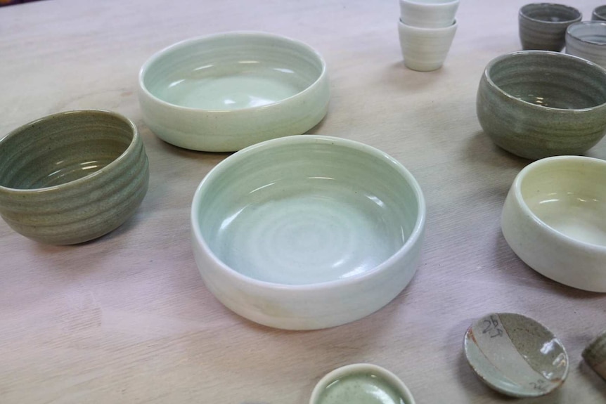 different shaped bowls in different shades of green