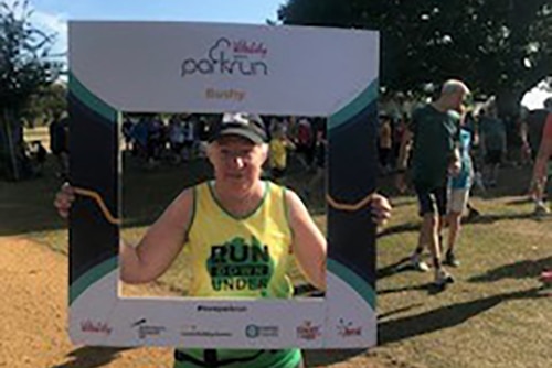 A woman running in the Bushy Park Parkrun in London.