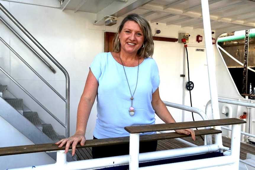 A photo of tourism operator Rachel Beaumont-Smith standing on a cruise boat.