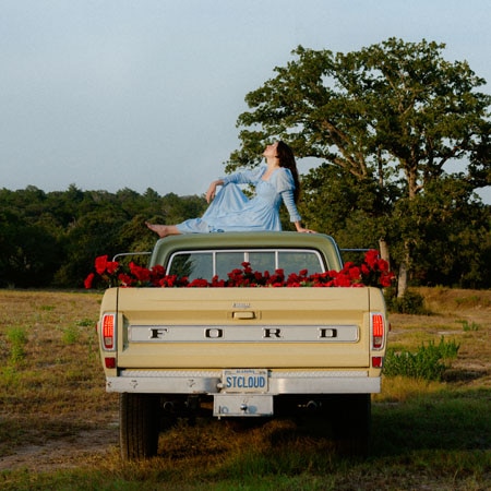 Katie Crutchfield sits atop a Ford pick-up truck on the cover of Waxahatchee's Saint Cloud