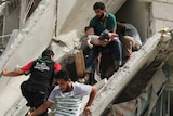 Syrian men remove a baby from the rubble of a destroyed building following a reported air strike in the Qatarji neighbourhood of the northern city of Aleppo on September 21, 2016