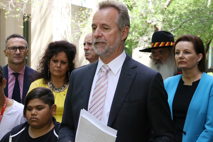 Nigel Scullion talks at a press conference.