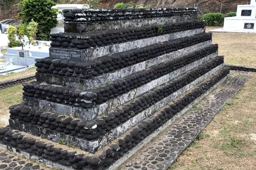 Black rocks form a six layered tomb. 