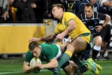 Ireland's Andrew Conway (L), scores a try against Australia in Melbourne on June 16, 2018.