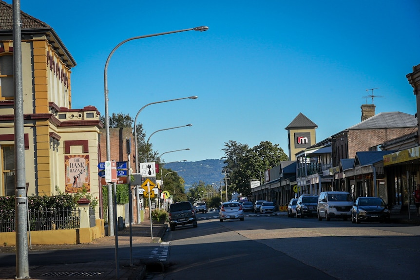 A streetscape with a mountain in the background.