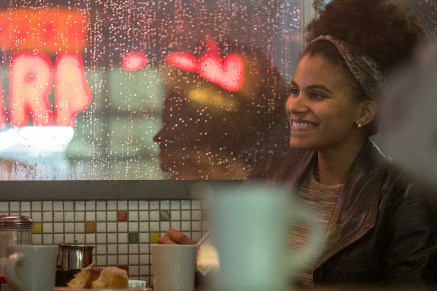 Actor Zazie Beetz in the movie Joker, a young black woman in a diner