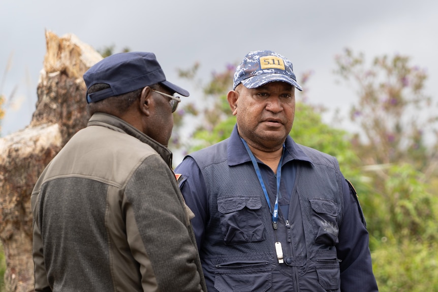 George Kakas stands in police uniform with another officer