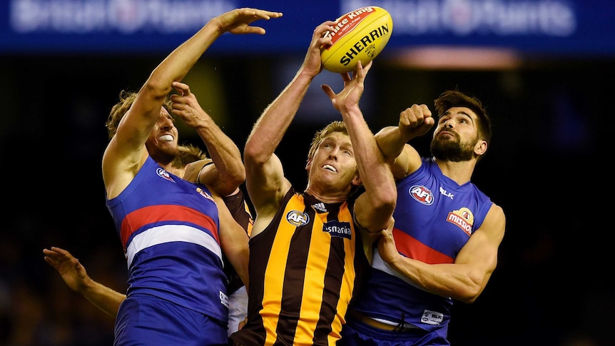 Lin Jong of the Western Bulldogs and Marcus Adams of the Western Bulldogs challenge Ben McEvoy