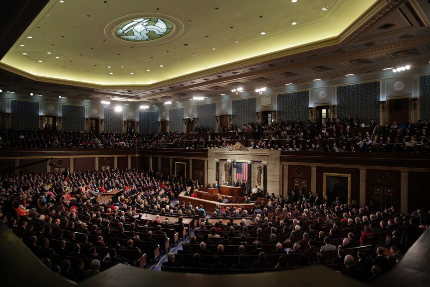 Barack Obama at the podium delivering a speech during a joint session of Congress.